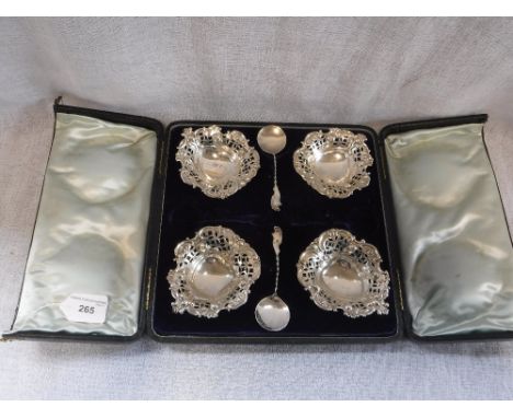 A CASED SET OF FOUR SILVER HEART-SHAPED SWEETMEAT DISHES by Walker & Hall of Sheffield, with a pair of matching silver twist 