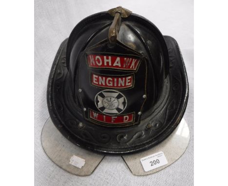 A VINTAGE AMERICAN MOHAWK FIRE ENGINE HELMET, label inside 'Cairns & Brother Inc., Clifton New Jersey' with original perspex 