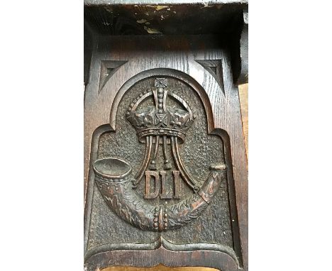 A Victorian Gothic Revival ash hand carved trestle type stool, inscribed with the badge of Durham Light Infantry, carved foli