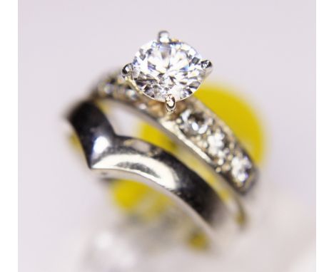 SOLITAIRE AND WISHBONE RINGS. Sterling silver fancy solitaire ring and a sterling silver wishbone ring, sizes K/L