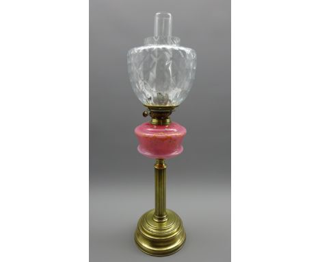 Table oil lamp with pink glass reservoir on a fluted brass column and with glass shade H63cms Condition Report & Further Deta