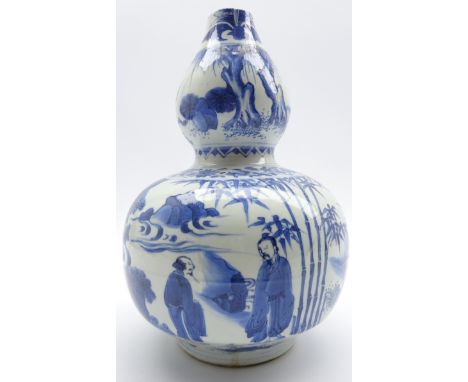 17th Century Chinese gourd shape vase decorated with a hunter chasing a stag, figures taking tea etc in blue and white H28cms