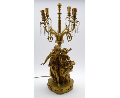 Gilt metal four branch table lamp hung with spear cut lustre drops, the stem formed as two classical figures, H81cms Conditio