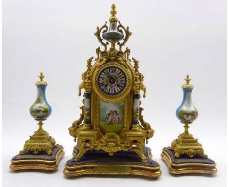 Late 19th century French clock garniture, gilt metal mantel clock with serves style porcelain urn above ribbon tie cresting, 