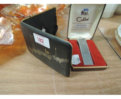 A Colibri Molectric lighter, cased and an oriental cigarette case