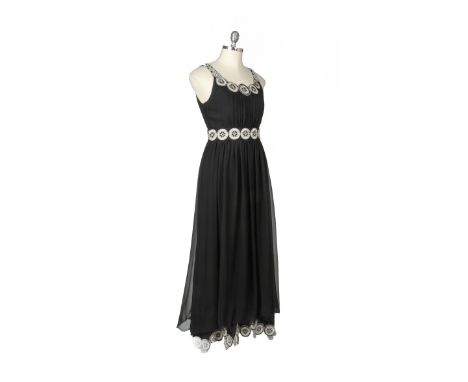 A GUCCI BLACK EVENING DRESS
With invisible side zipper, the waist, collar and straps embellished with an interlinking metalli