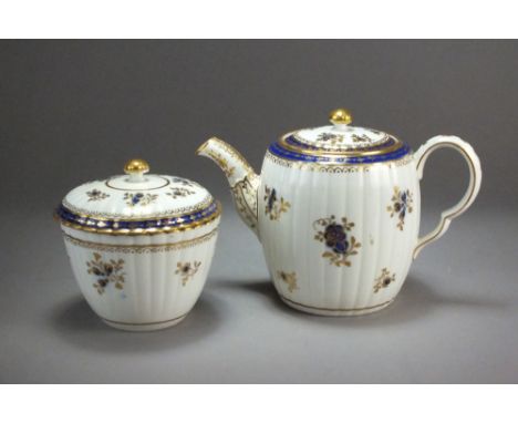 Caughley porcelain blue and gilt wares, circa 1790, to include a barrel-form lobed teapot and cover, S mark, 15cm high, a suc