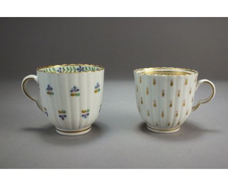 Two Caughley porcelain fluted coffee cups, circa 1790, the first with in polychrome with Derby style sprigs, the second in gi