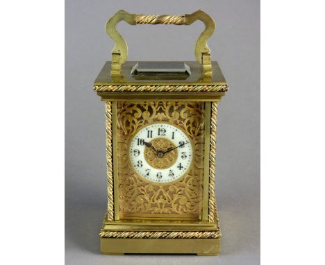 A brass cased carriage clock, the five panel case with platform lever escapement and 5cm white enamel annular dial with Arabi