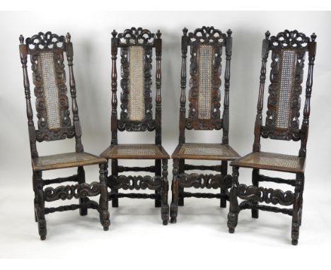 A set of four oak high back dining chairs, Charles II and later each with c-scroll cresting and cane seat panel back within t