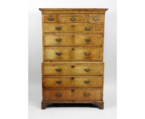 A crossbanded walnut chest on chest, 18th century the ogive cornice above three short draws and three long graduated drawers 