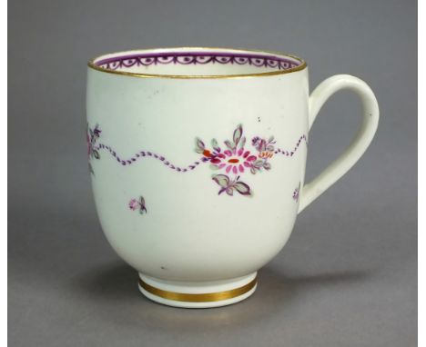 A Caughley polychrome porcelain coffee cup, circa 1785, painted with a single band of pink and green flowers with puce ribbon