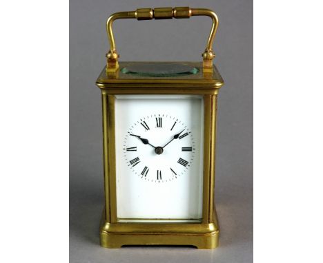 A brass carriage clock with five glass case, platform lever escapement, white enamel dial with Roman numerals, eight day move