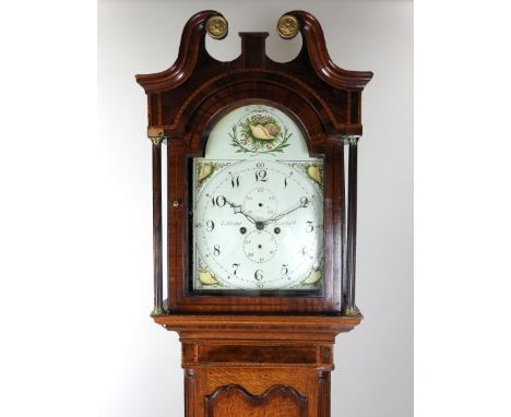 A George III oak and mahogany crossbanded longcase clock, the broken scroll swan neck pediment above an arched glazed door en