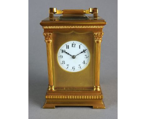 A French gilt brass cased carriage clock the bevelled five panel glass case with platform lever escapement and 5cm white enam