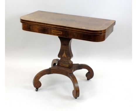 A Regency rosewood and boxwood strung card table, early 19th century, the rectangular fold over top with rounded front corner