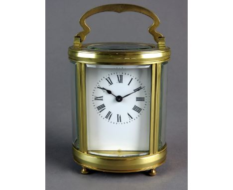 A French oval brass carriage timepiece with five glass case and platform lever escapement, white enamel dial with Roman numer