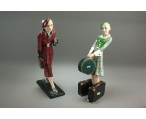 Two Goldscheider Art Deco pottery figures modelled as a lady in red tartan full-length coat, holding a single small suitcase 