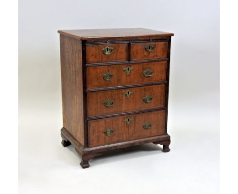 A walnut crossbanded chest of drawers, George I and later, the crossbanded and herringbone inlaid rectangular top above a bru