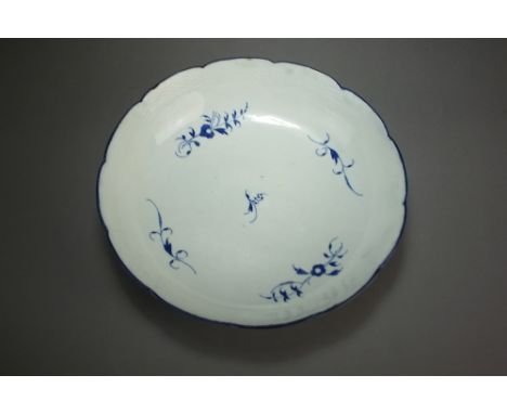 A Caughley porcelain shallow bowl painted with the Gillyflower pattern, circa 1785-90, within basket-weave border, S mark, 24