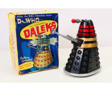 Marx - Dr Who - A boxed 1964 dated battery operated Dalek in black. The model shows some signs of age and use with some glue 