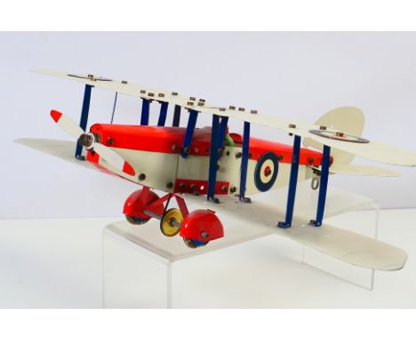 MECCANO - a built tinplate Meccano aeroplane model of a biplane approx 36 cm long and 46cm wingspan, with pilot, single prope