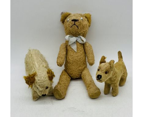 A vintage Chiltern mohair toy dog, along with a Chad Valley terrier and antique teddy bear with replacement eyes