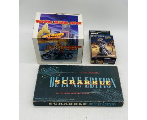 A boxed Zeon Biker Mice From Mars Talking Alarm Clock, along with a Scabble Deluxe Edition and Tomy Super Zoids