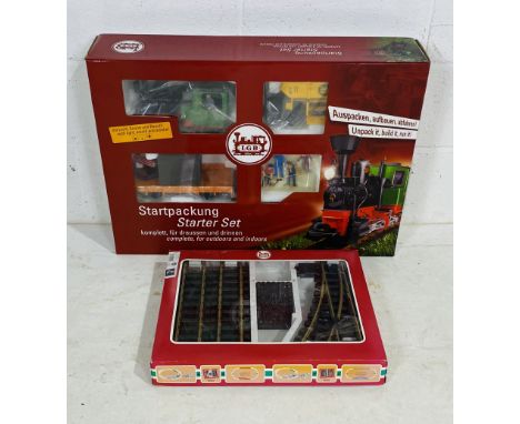 A boxed Lehmann LGB G scale model railway "Starter Pack" set including a locomotive, two wagons, power supply, four figurines