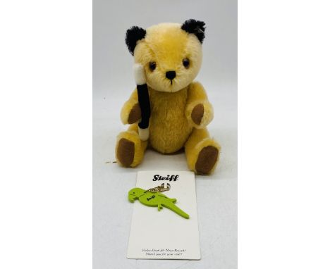 A vintage unboxed Steiff "Sooty" teddy bear, along with a Steiff parrot keyring