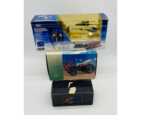 A boxed Universal Hobbies Massey Fegusson MF 35X die-cast tractor (1:16 scale), along with Silverlit Electronics Picooz remor