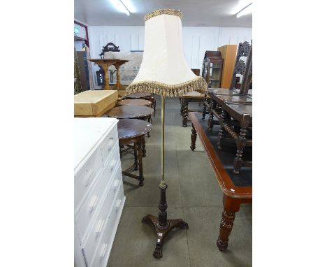 A brass and carved mahogany standard lamp