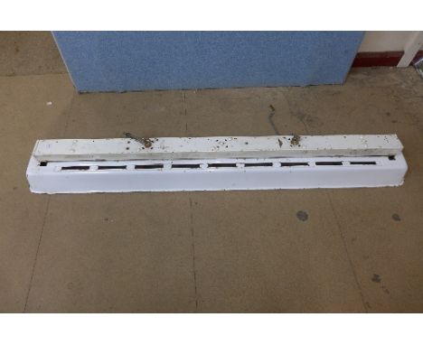 A vintage industrial overhead enamel strip light