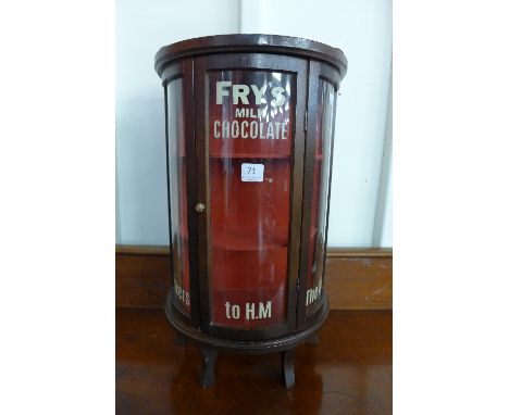 A small mahogany bow front display cabinet, bearing painted Fry's Milk Chocolate inscription