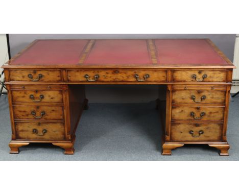 A GOOD QUALITY REPRODUCTION YEW WOOD PEDESTAL DESK, inset tooled crimson leather, fitted three frieze drawers to the front &a