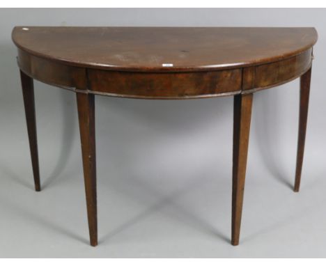 A mahogany demi-lune console table on four square tapered legs, 44¾” wide x 26¾” high x 22¼” deep; together with a reproducti