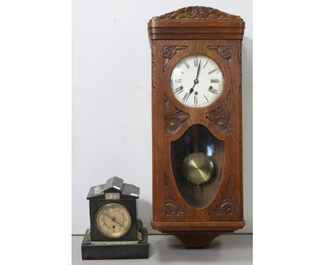A mid-20th century wall clock, with black Roman numerals to the white enamel dial, &amp; in carved oak case, 32” high; &amp; 