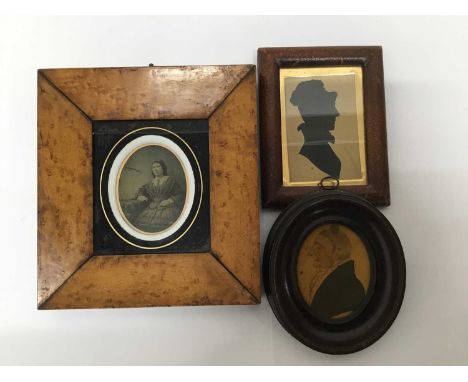 Three 19th century miniatures to include a daguerreotype in burr maple frame, watercolour portrait and a silhouette, each fra