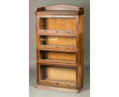 *Bookcase. A 1920s Globe Wernicke style oak bookcase by Lebus,  four tiers each with hinged glass door with dentil moulded fr