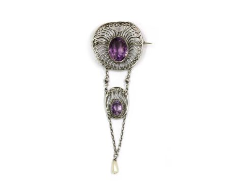 A silver Arts and Crafts amethyst and dog tooth pearl brooch, c.1910, a lily pad shaped brooch with an oval mixed cut amethys