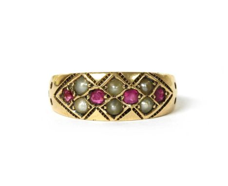 A Victorian 15ct gold ruby and split pearl ring, with mixed cut rubies and split pearls grain set in a lattice to the slightl