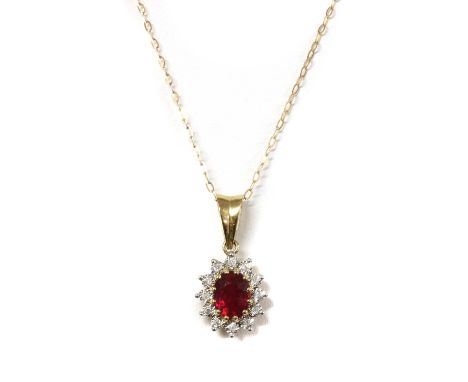 A 9ct gold fracture filled ruby and diamond cluster pendant, with an oval mixed cut fracture filled ruby, approximately 8 x 6