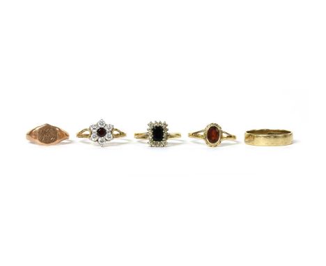 Five 9ct gold rings, to include a single stone garnet ring, Edinburgh, a shield shaped signet ring with engraved initials, ha