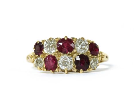 A gold ruby and diamond ring, with two rows of alternating old brilliant cut diamond and mixed cut rubies, all claw set to re