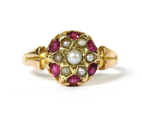 A Victorian 15ct gold split pearl and ruby cluster ring, with a split pearl grain set to a star collet at the centre, to bord