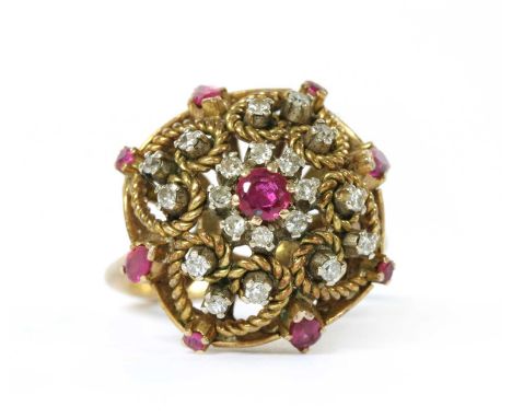 A gold synthetic ruby and diamond cluster ring, with a synthetic ruby and diamond cluster to the centre of an openwork twiste