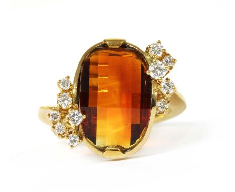 A German 18ct gold citrine and diamond ring, with an oval mixed cut citrine, end set, with a cluster of brilliant cut diamond