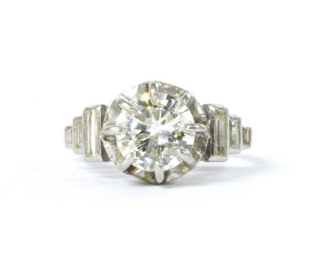 A single stone diamond ring, with diamond set shoulders, with a brilliant cut diamond, with a stated weight of 1.34ct, claw s