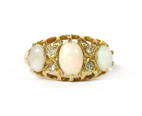 A Victorian 18ct gold opal and diamond ring, with a row of three graduated oval cabochon opals, with a pair of brilliant and 