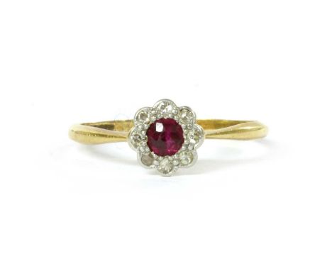 A gold ruby and diamond cluster ring, with a round mixed cut ruby, grain set, to surround of eight cut diamonds, grain set to